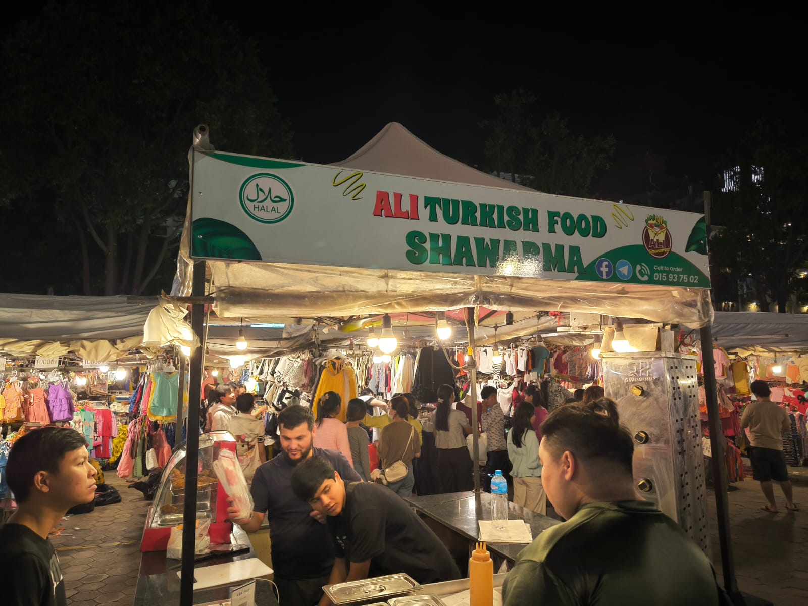 Night market street scene with visitors